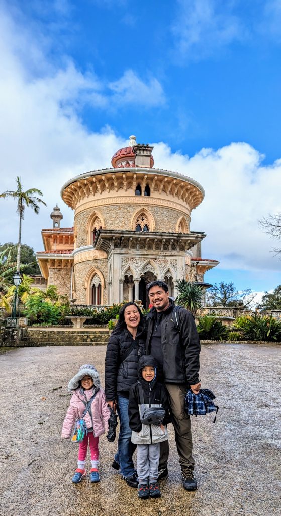 A family of four stands in front of the ornate Monserrate Palace.